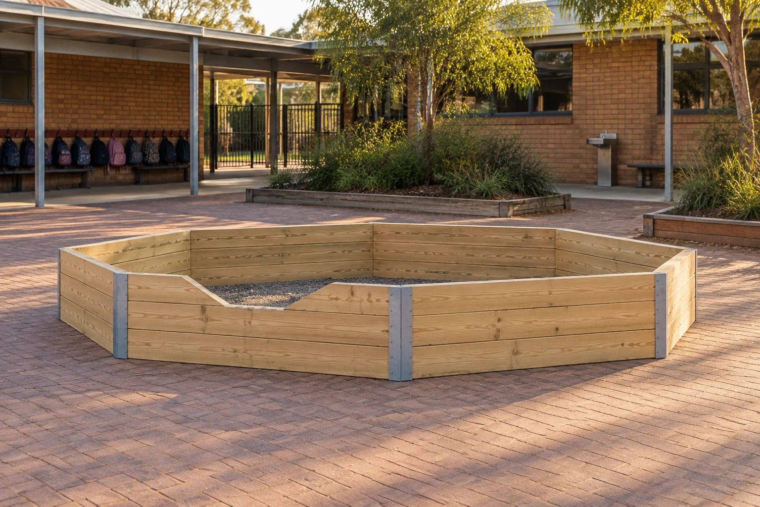 A 60 cm gaga pit built from pine sleepers and steel corner brackets on a school paved courtyard